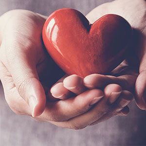 hands holding a ceramic heart