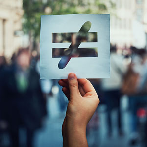 hand holding an unequal sign